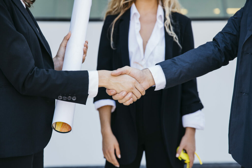 businessman businesswoman shaking their hands